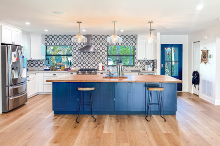 Modern Kitchen Remodel with Bold Backsplash and Blue Island