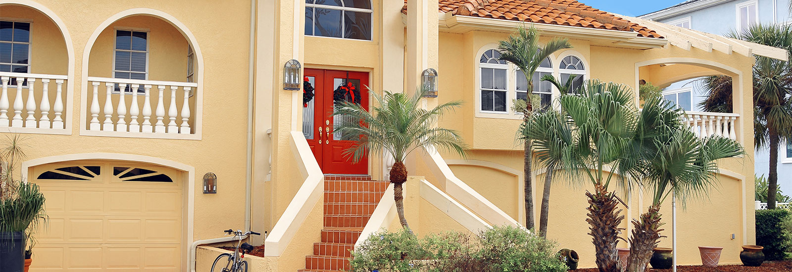 Exterior Front View of Yellow House with Red Door